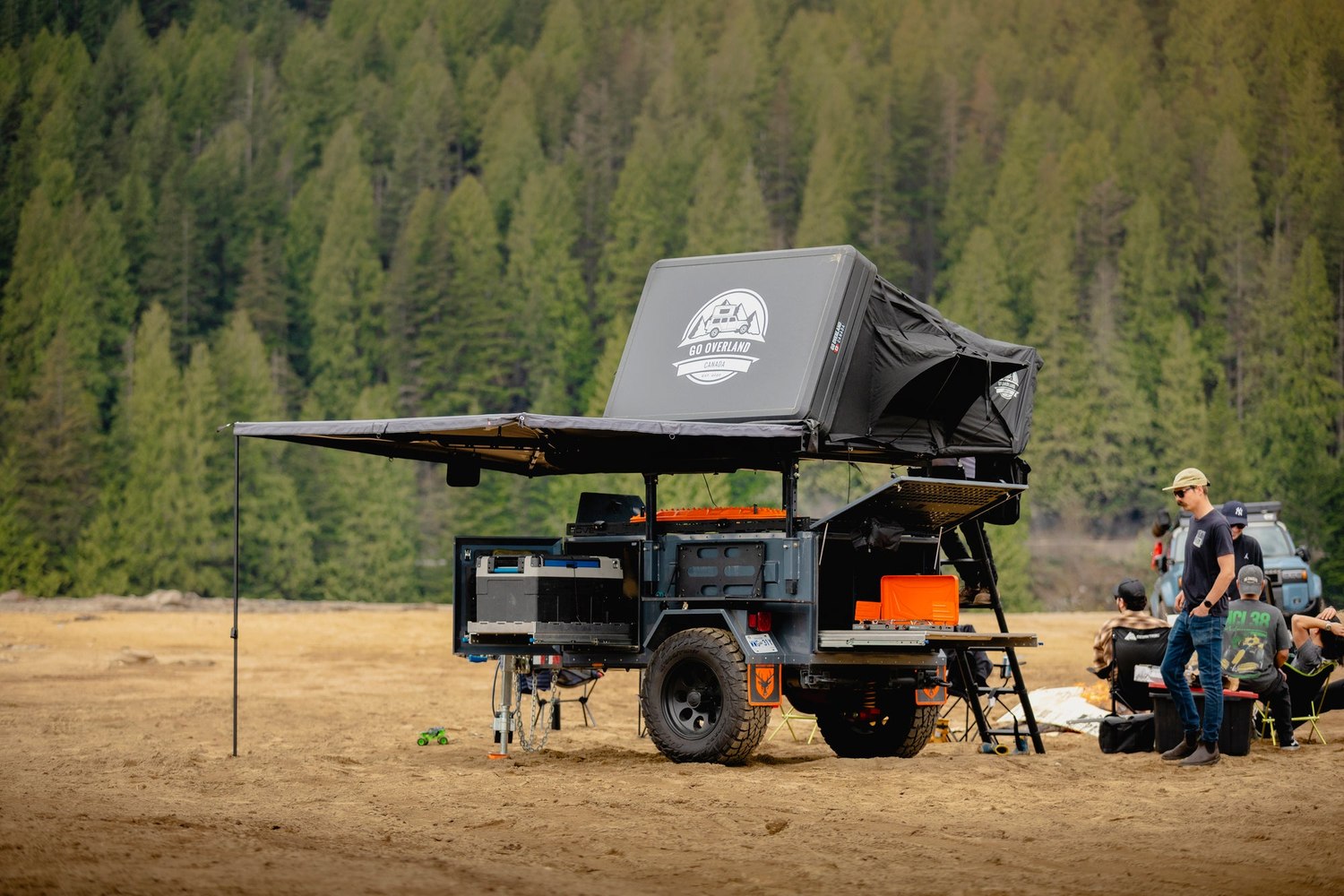 A Rove Recon set up at camp with the awning out and the rooftop tent deployed