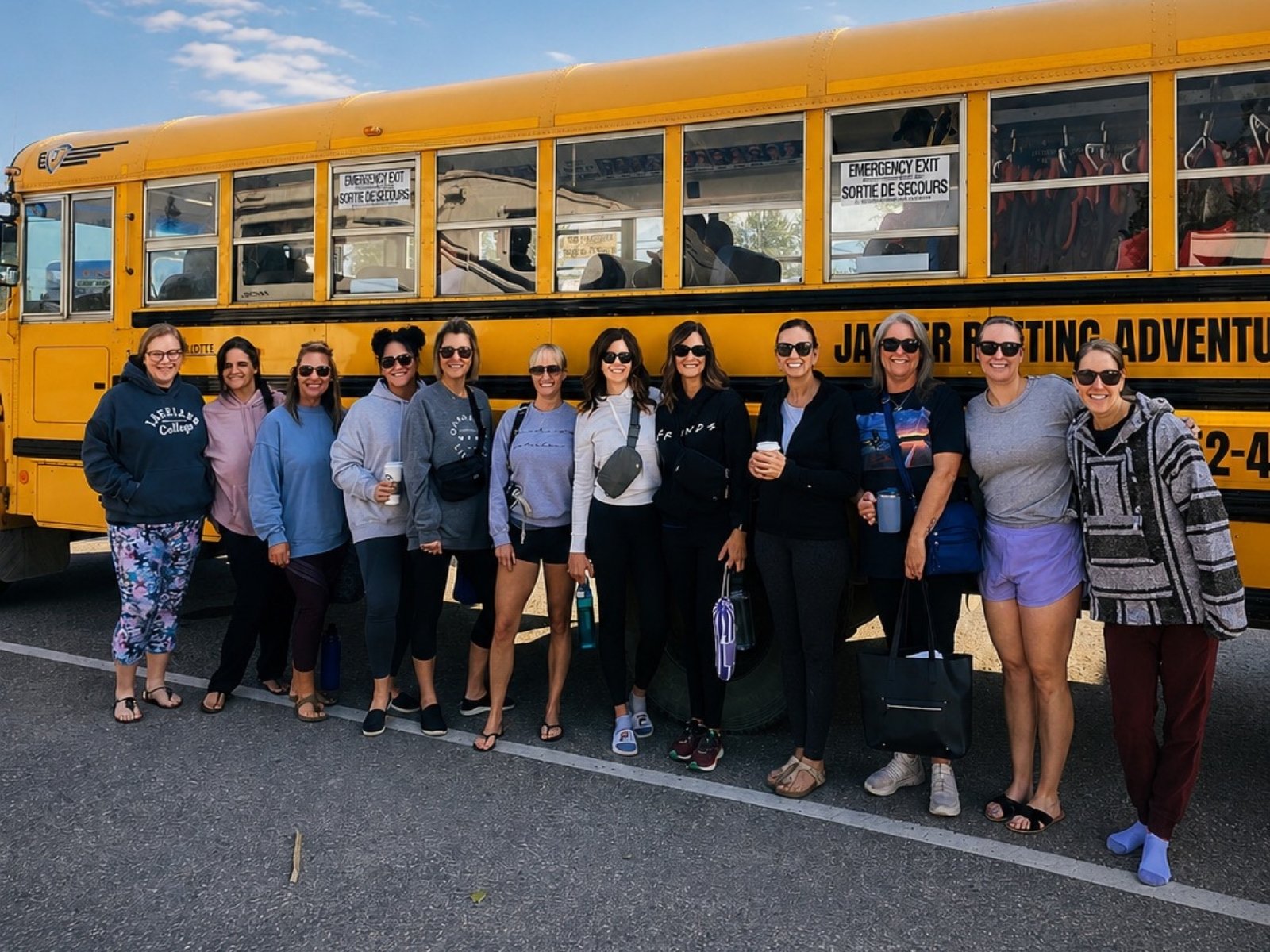 A retreat group gathered beside the bus at the start of a day out